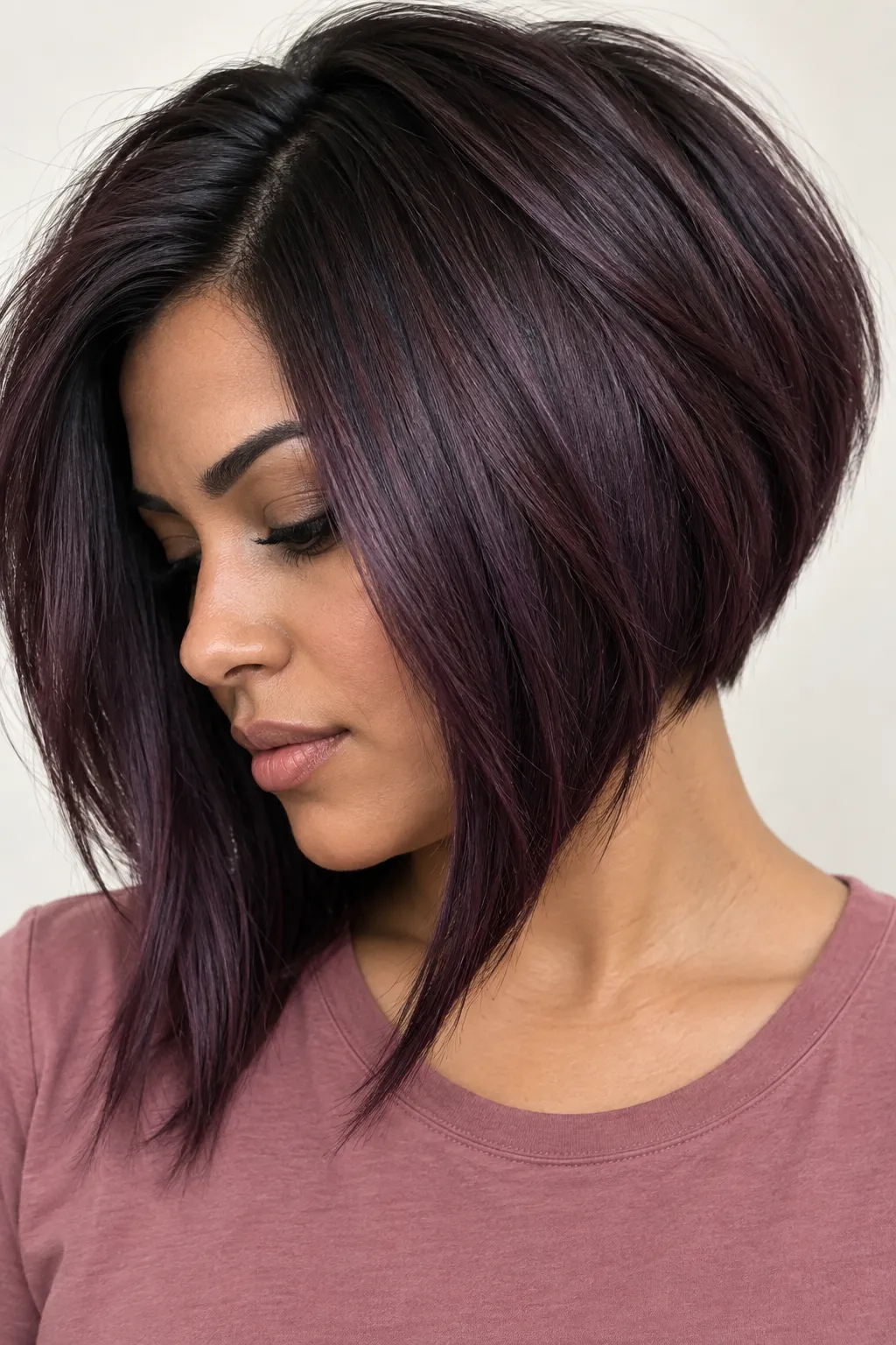 Dark plum inverted bob with a side part and longer front sections