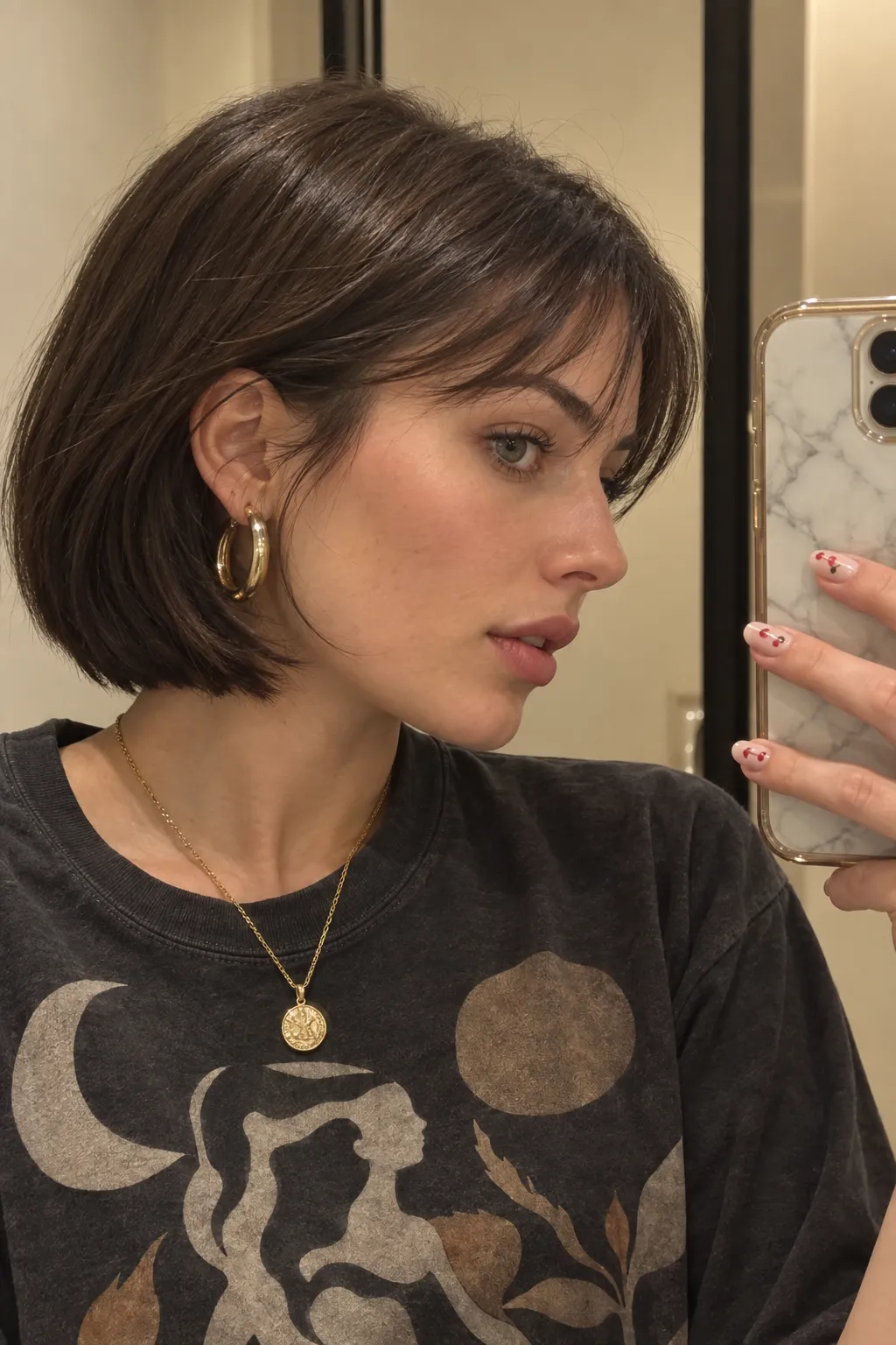 Sleek bob tucked behind one ear with wispy bangs framing the forehead.