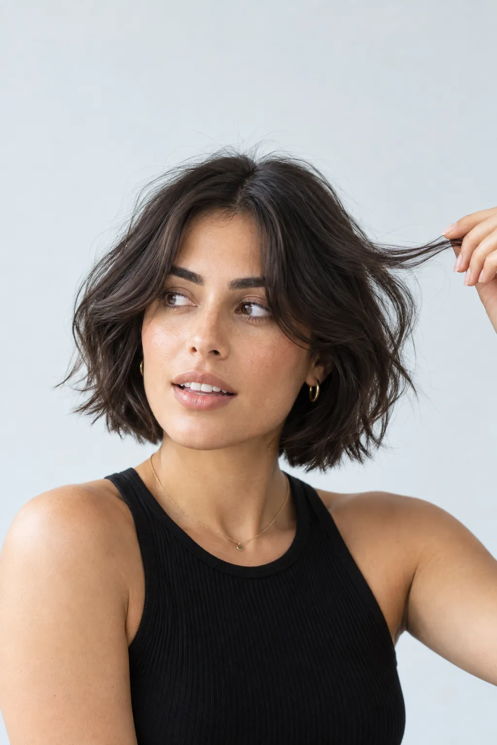 Textured dark bob with soft curtain bangs and separated lengths